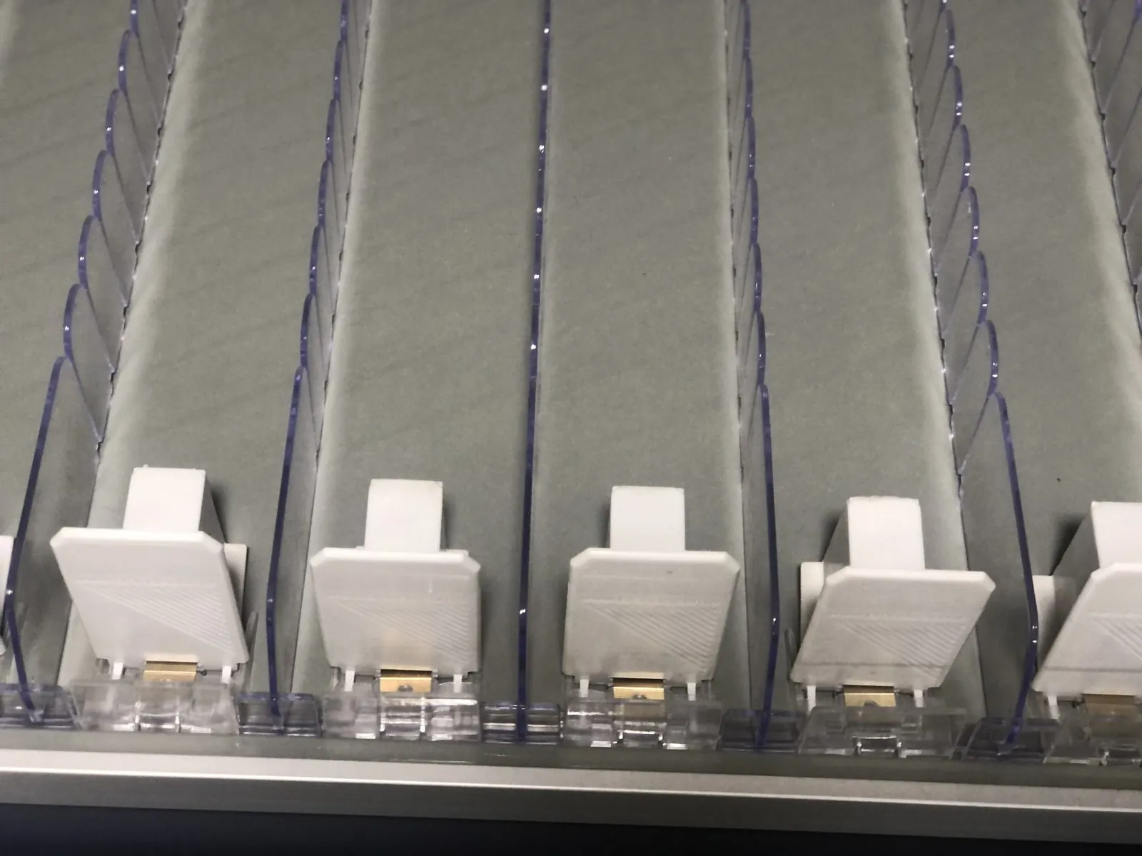 Injection-moulded pusher trays fresh off the line, lined up for fitting.