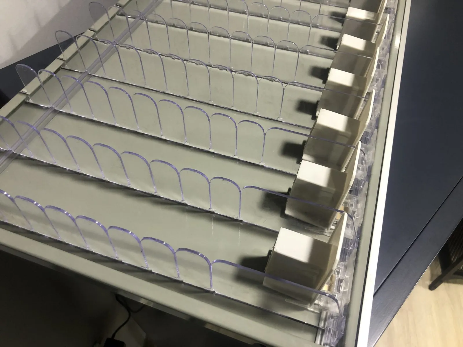 Pusher channels assembled into a shelf frame during production.