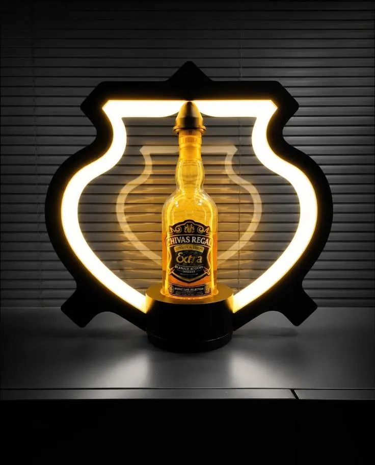 Shield-shaped illuminated light box on a dark wall, with a whiskey bottle silhouette glowing at its centre.
